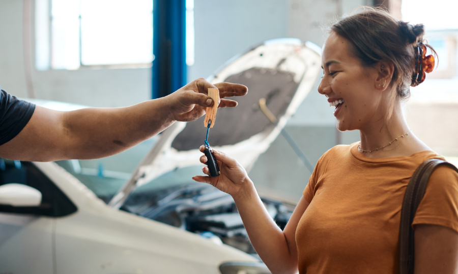 Woman receiving her car keys back from a mechanic