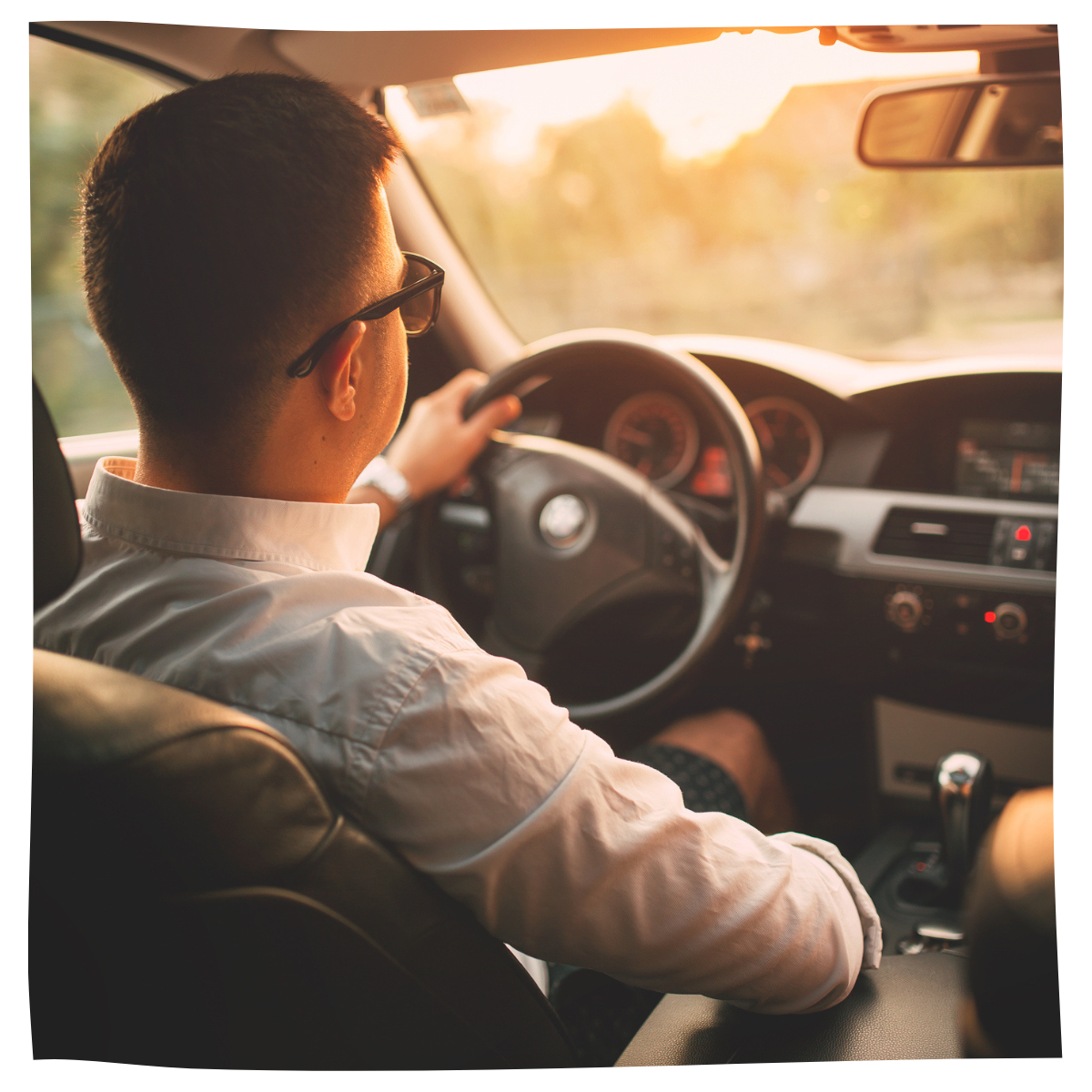 Man driving his car at sunset