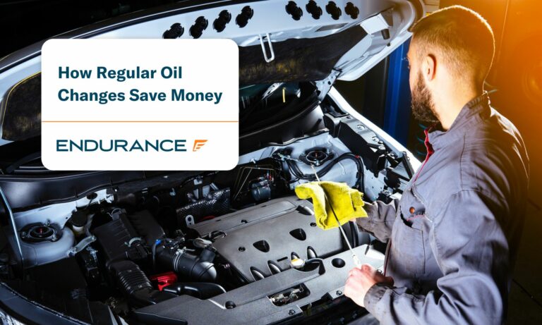 Auto technician checking the engine oil in a car