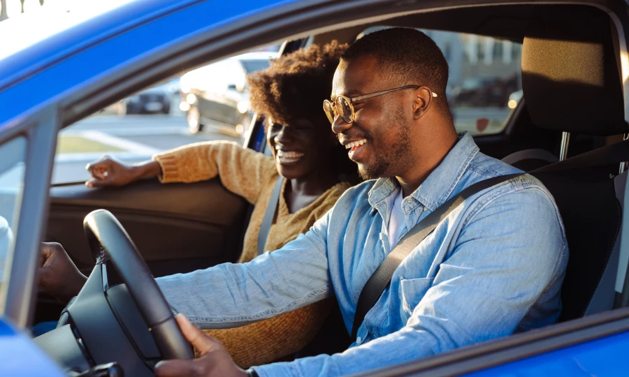 Cheerful African American couple in car
