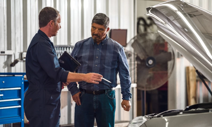 Certified mechanic Keith Benline talking with a customer