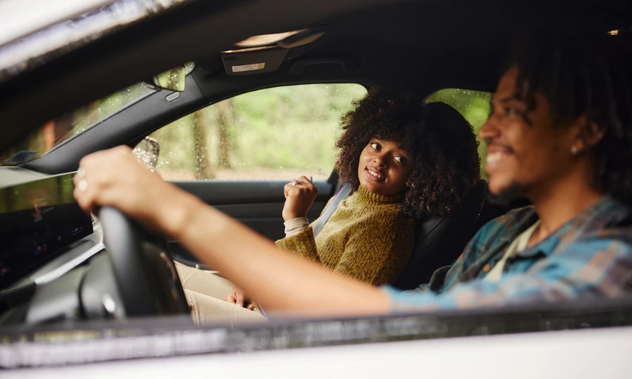 Happy African American woman going on a road trip with her boyfriend