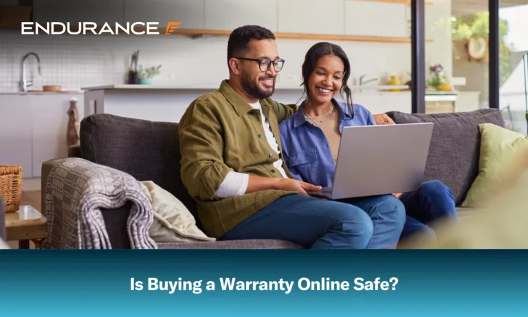 A couple sitting on a couch using a laptop at home