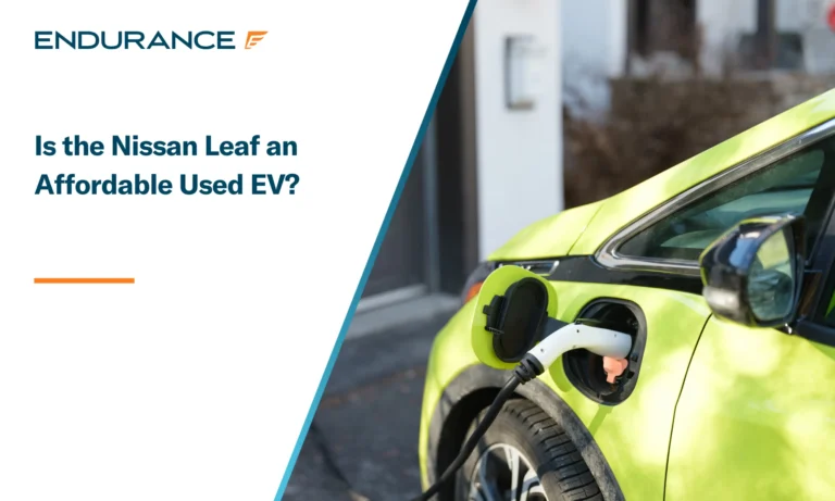 Electric car charging near a garage in the suburbs