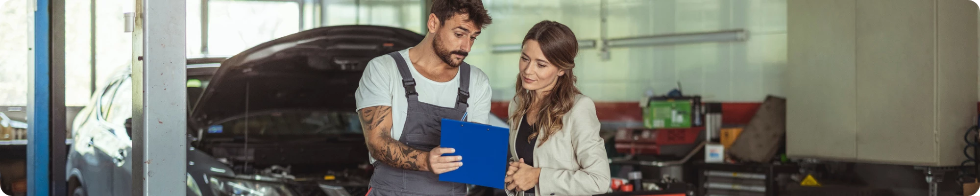 Mechanic and customer talking together at the repair garage