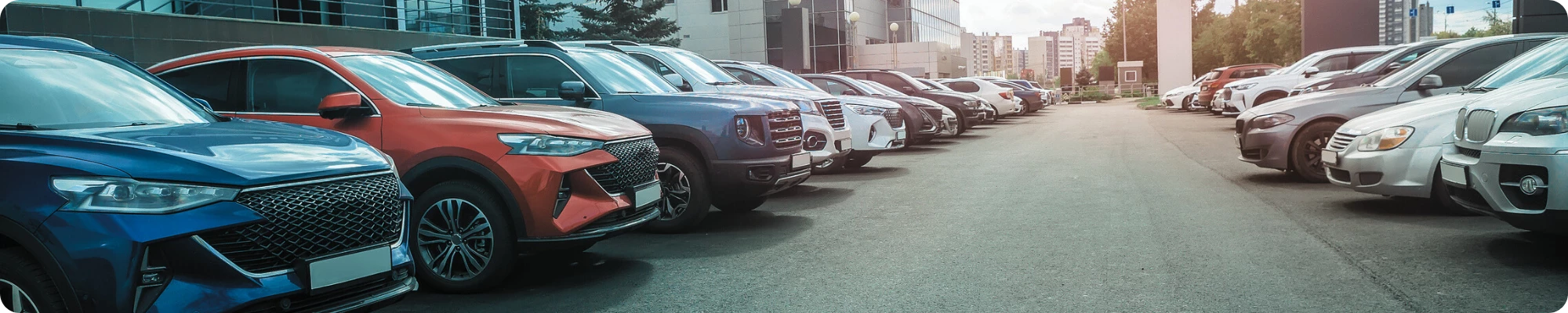 Cars for sale in a dealership parking lot