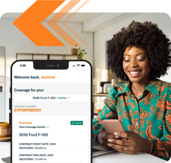 Woman at home smiling while accessing the Endurance Customer Portal on her phone
