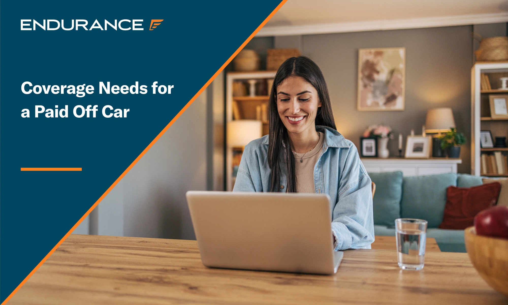 A cheerful woman sitting at the table in the living room at home and using a laptop