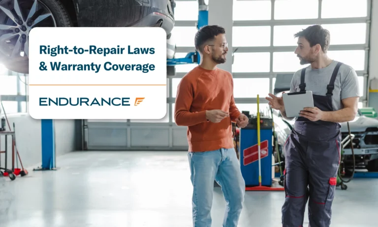 Customer and automotive technician talking in a workshop