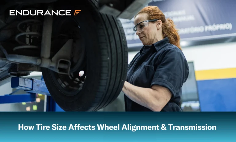 Female auto mechanic changing the wheel of a car at a repair shop