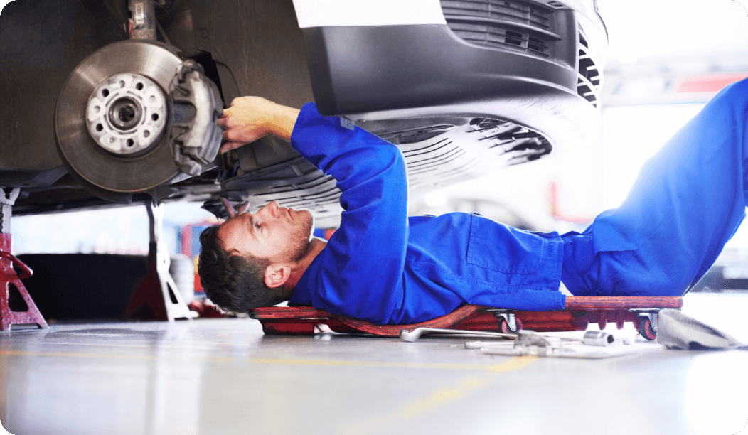 Mechanic working underneath car