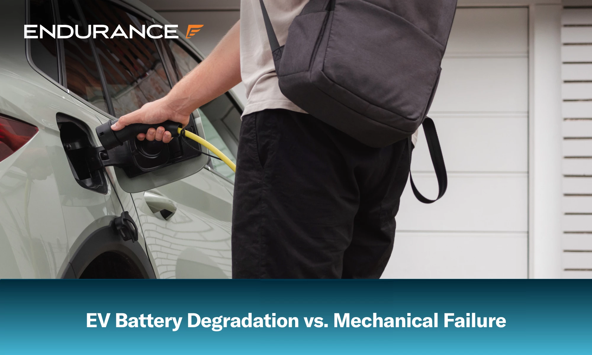 Young man charging electric car at the charging station at home