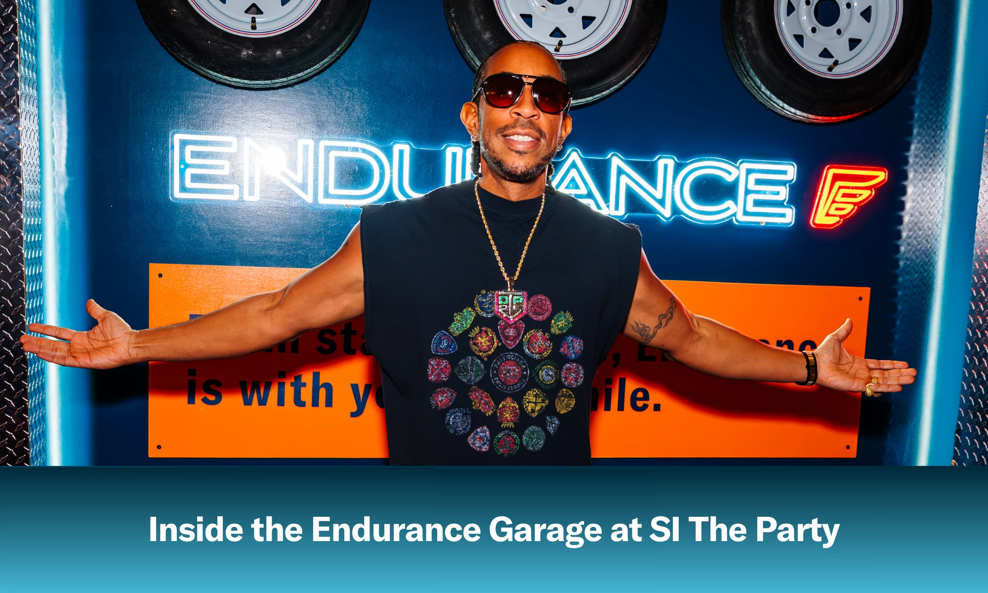 Ludacris posing in front of an Endurance sign at SI The Party