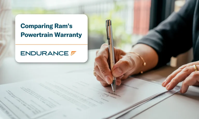 A person's hand signing contract, comparing Ram's powertrain warranty with third party coverage