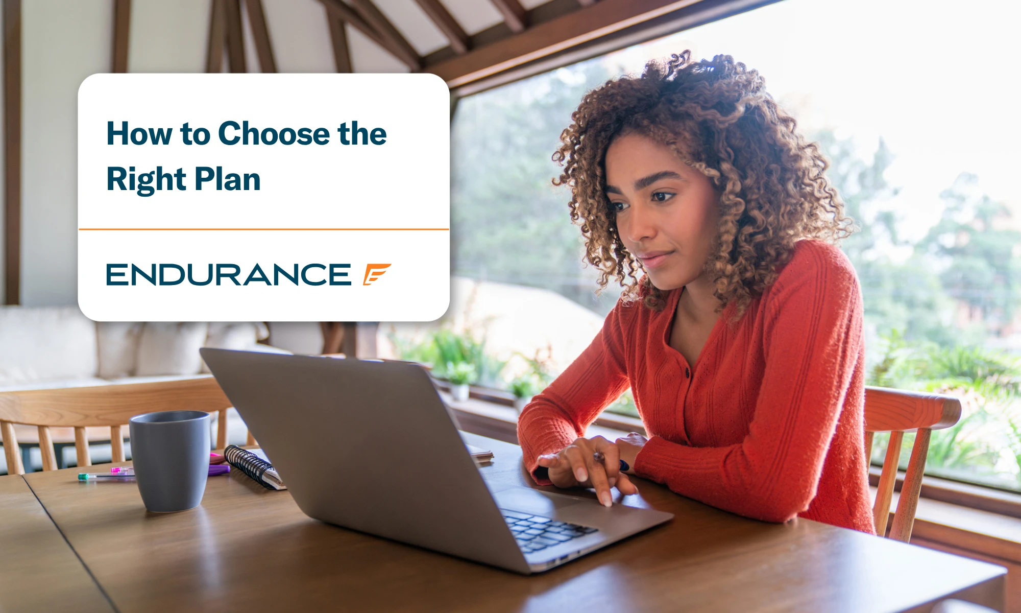 Young woman working at home using her laptop, learn how to choose the right Endurance protection plan