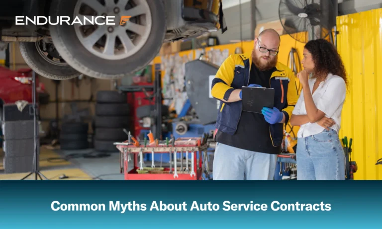 Mechanic checks car engine while customer looks on, Myths about auto service contracts