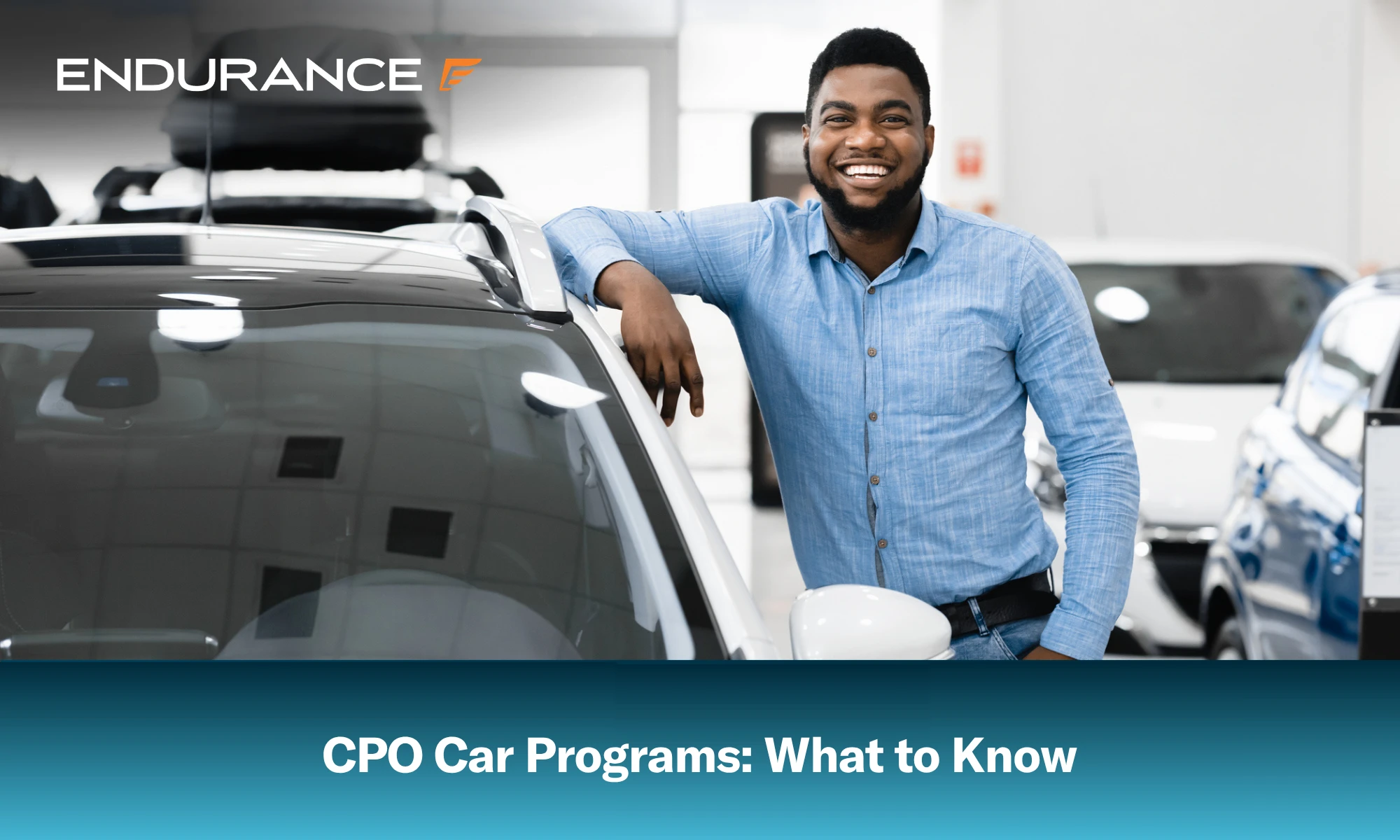 Happy man standing next to a car at a dealership, what to know about CPO car programs