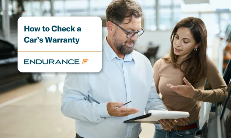 Woman with car salesperson in a showroom, how to check if your car is still under warranty