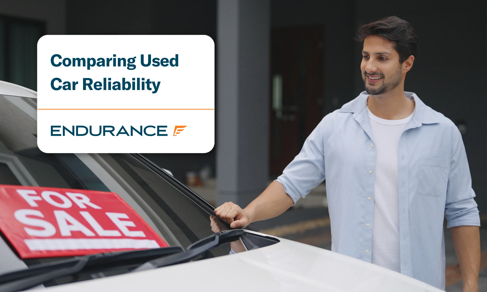 A young man looking at a used car for sale, comparing used car reliability